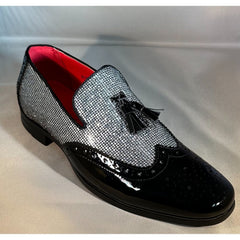 A men's silver glitter slip-on loafer with a black patent leather wingtip toe and tassel detail.