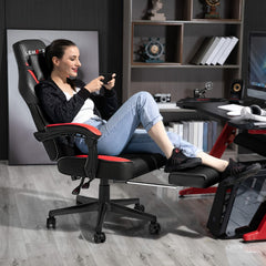 A woman sits in a black and red ergonomic gaming chair with a retractable footrest.