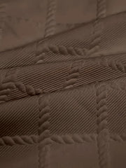 Close-up of a men's casual t-shirt featuring a textured geometric jacquard knit pattern.