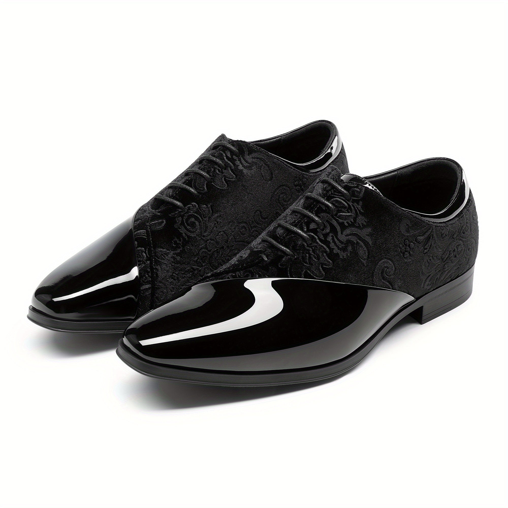 A pair of black men's dress shoes featuring a glossy patent toe and a patterned velvet upper.