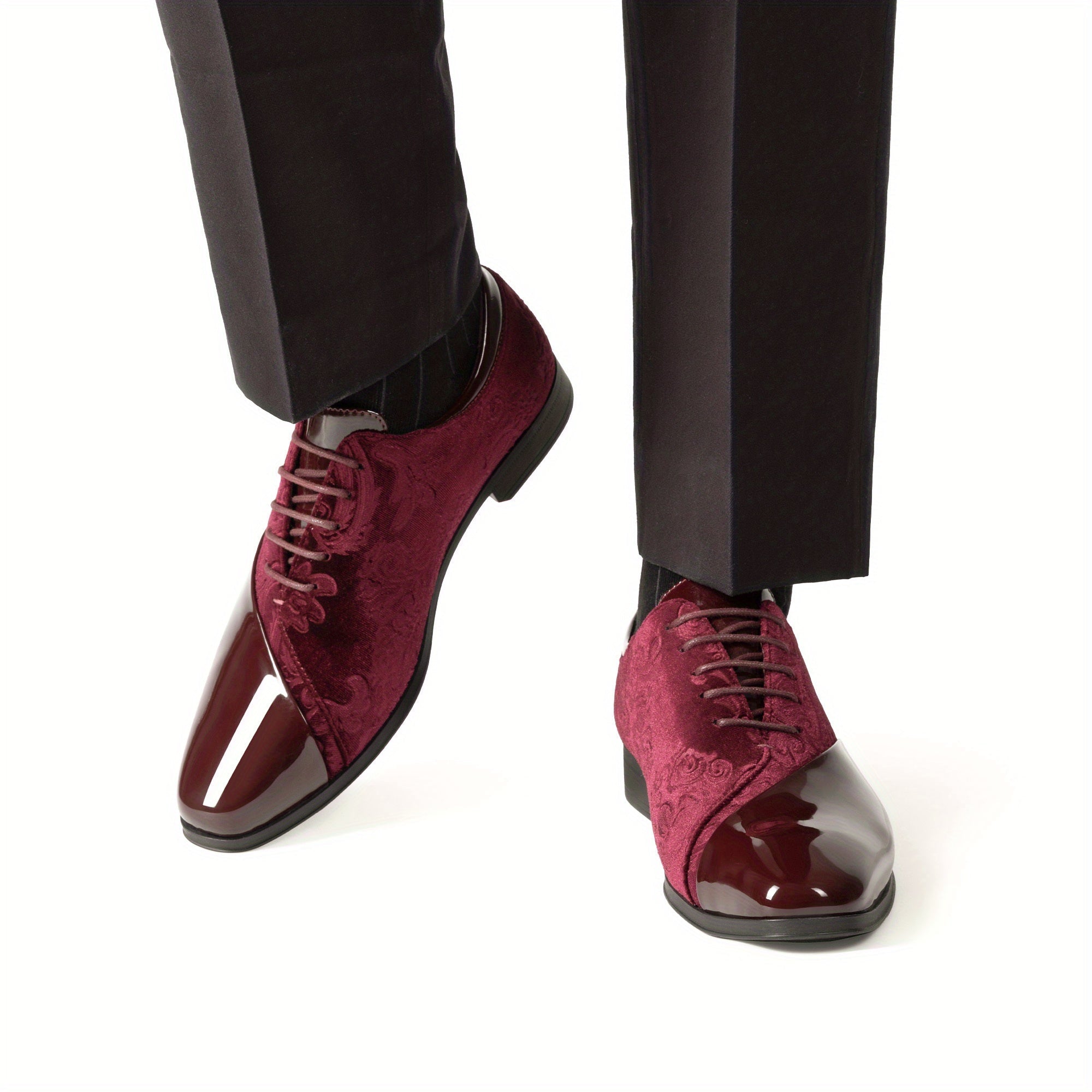 A pair of burgundy velvet and glossy patent leather men's lace-up oxford dress shoes.