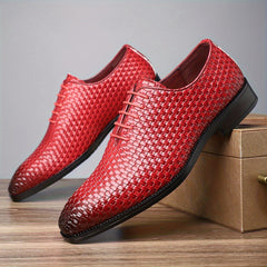 A pair of red woven-texture men's lace-up Oxford shoes with black rubber soles.