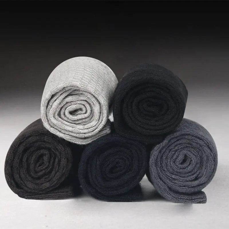 Ten pairs of men's bamboo fiber socks in black, size 42-45, are stacked in a pyramid shape. They feature compression support and are suitable for business or casual wear, perfect as an autumn gift.