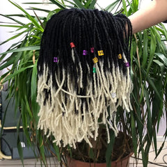A short black and blonde ombre synthetic dreadlock wig decorated with colorful hair beads.