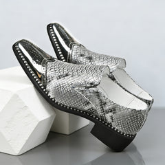 Men's slip-on formal shoes featuring a silver metallic brogue toe and grey snakeskin pattern.