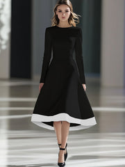 A woman wears a black long-sleeve midi dress with a white hem and a cinched waist.