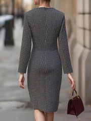 A woman wears a fitted, long-sleeve black and white houndstooth dress with a crew neckline.