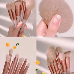 A set of thirteen makeup brushes with soft beige bristles and metallic copper handles.