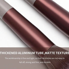 Two makeup brushes with matte aluminum handles and soft bristles lie on a light surface. Text overlay highlights their quality and durability as part of the 13 PCS Makeup Brushes Set for eye shadow, foundation, blush, and more.
