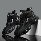 A pair of black mid-top men's running shoes with lace-up closures and the number 23 printed on them.