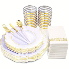 A set of white disposable plates, cups, gold-toned plastic cutlery, and napkins with gold accents.