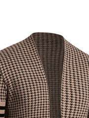 A close-up of a tan and black houndstooth knit cardigan with a stand collar.
