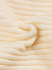 A close-up view of a cream-colored, ribbed knit fabric with a soft, textured appearance.