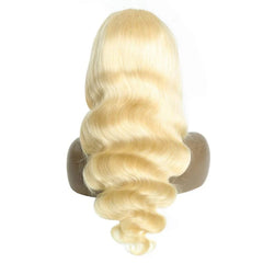 A blonde human hair wig with a wavy texture displayed on a mannequin head.