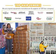 A woman holding packaged human hair wigs in front of stacks of shipping boxes.