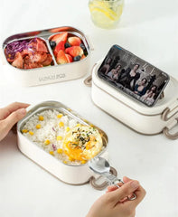 A white double-layer stainless steel bento box with a phone stand lid and a side dish container.