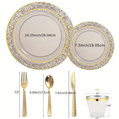 A set of clear plastic plates, cups, and gold-colored cutlery with textured rims and handles.
