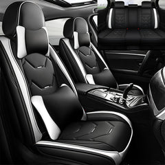 Black and white faux leather car seat covers with matching pillows for front and rear seats.