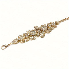 A golden-toned rhinestone chain belt featuring a sparkling leaf-inspired design.
