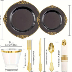 A set of black plastic plates with gold rims, gold cutlery, clear cups, and pre-rolled napkins.