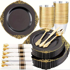 A set of black plastic plates with gold rims, gold cutlery, cups, and pre-rolled napkins.
