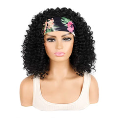 A mannequin wears a medium-length black kinky curly wig styled with a floral headband.