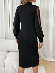A woman wears a black midi dress with long sleeves featuring sheer mesh panels.