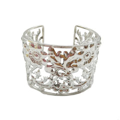 A silver-plated open cuff bracelet featuring an intricate floral and filigree cutout design.