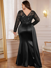 A plus-size black mermaid gown featuring a sequin lace bodice, long sleeves, and a satin skirt.