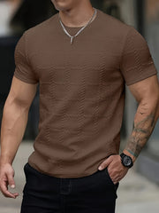 A brown short-sleeve crew neck t-shirt featuring a textured geometric jacquard knit pattern.