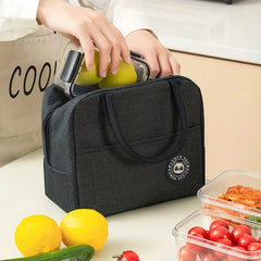 A person places a glass container into a black insulated lunch bag with a panda logo.