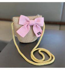 The 2-8 Years Kids Sun Hat Girls Summer New Straw Bag Cap Set features a woven straw purse with a yellow strap and pink bow, reminiscent of a sun hat, perfect for travel or beach outings.