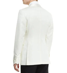A man wearing a white single-button blazer with a shawl lapel and black trousers.
