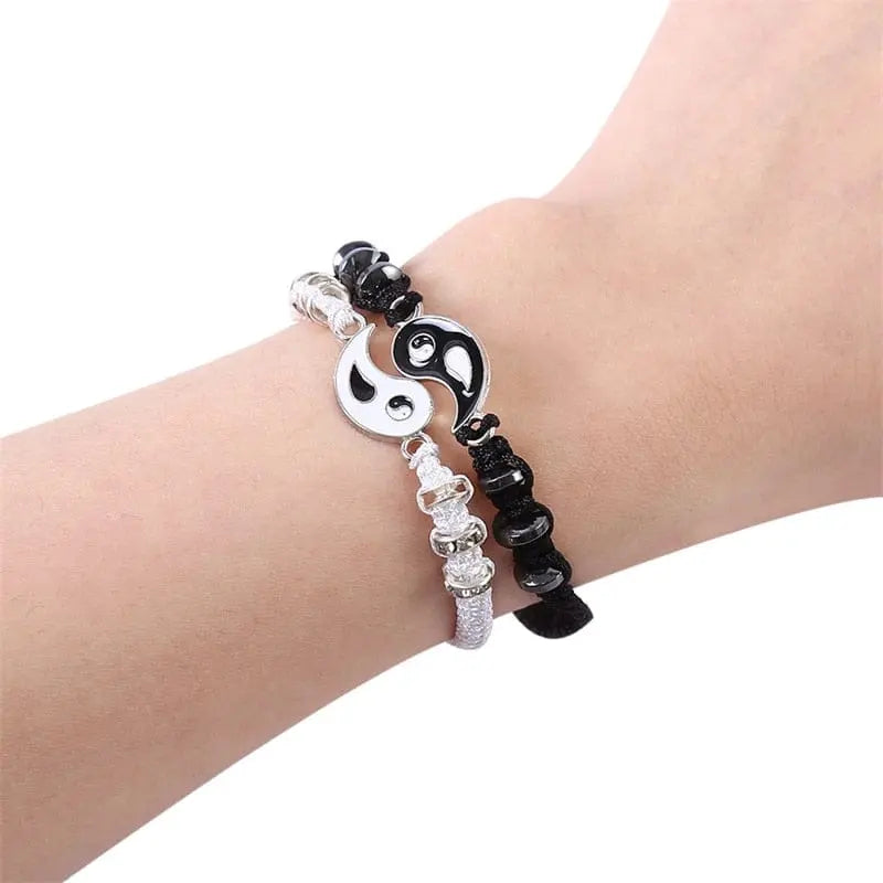 A wrist wearing two 2022 New Best Friend Bracelets for 2—matching yin yang adjustable cord bracelets with alternating shiny and matte beads, perfect for BFF, friendship, boyfriend or girlfriend.