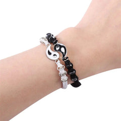 A wrist wearing two 2022 New Best Friend Bracelets for 2—matching yin yang adjustable cord bracelets with alternating shiny and matte beads, perfect for BFF, friendship, boyfriend or girlfriend.