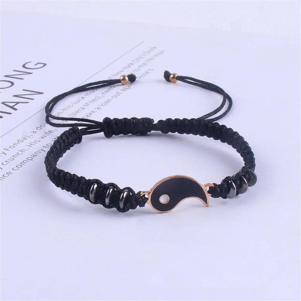 A black adjustable cord bracelet with a gold-edged black yin yang pendant and black beads, shown on a white background; perfect as 2022 New Best Friend Bracelets for 2, matching BFF friendship or relationship jewelry.