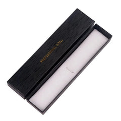 An open black rectangular storage box with a white interior lining for a professional nail brush.