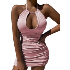 A person models the 2023 Summer Party Dress—an elegant women's sexy bodycon mini with a halter neckline, solid light pink color, and a hollow keyhole cutout—standing confidently with one hand on their hip.