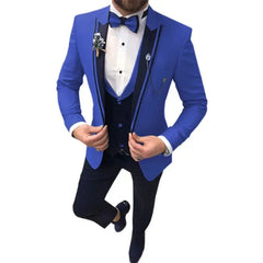 A man wears a royal blue three-piece suit with a black vest, lapels, and a matching bow tie.