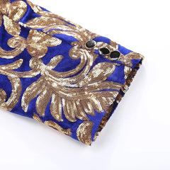 A close-up of a blue velvet blazer sleeve featuring intricate gold sequin floral embroidery.