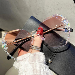 Rimless gradient sunglasses featuring decorative rhinestones along the edges of the lenses.