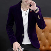 A slim-fit purple velvet blazer for men with a single-button closure and gold-tone buttons.