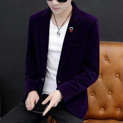 A man wears a slim-fit purple velvet blazer with a single-breasted button closure.