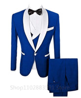A three-piece royal blue men's suit featuring a white shawl lapel, a matching vest, and trousers.