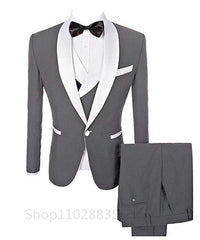 A grey three-piece men's suit featuring a white shawl lapel, a matching vest, and trousers.