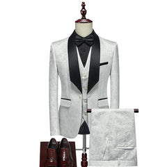 A white floral patterned three-piece men's suit with a black shawl lapel, vest, and bow tie.