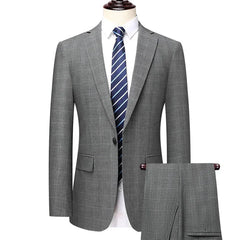 A grey checkered two-piece suit for men featuring a single-breasted blazer and matching trousers.