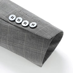 A close-up of a grey checkered suit sleeve cuff featuring four white buttons.
