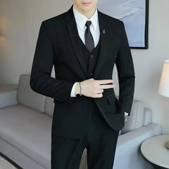 A man wears a black three-piece suit consisting of a single-breasted jacket, vest, and trousers.