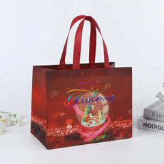A red non-woven Christmas gift bag featuring a snow globe graphic and sturdy handles.